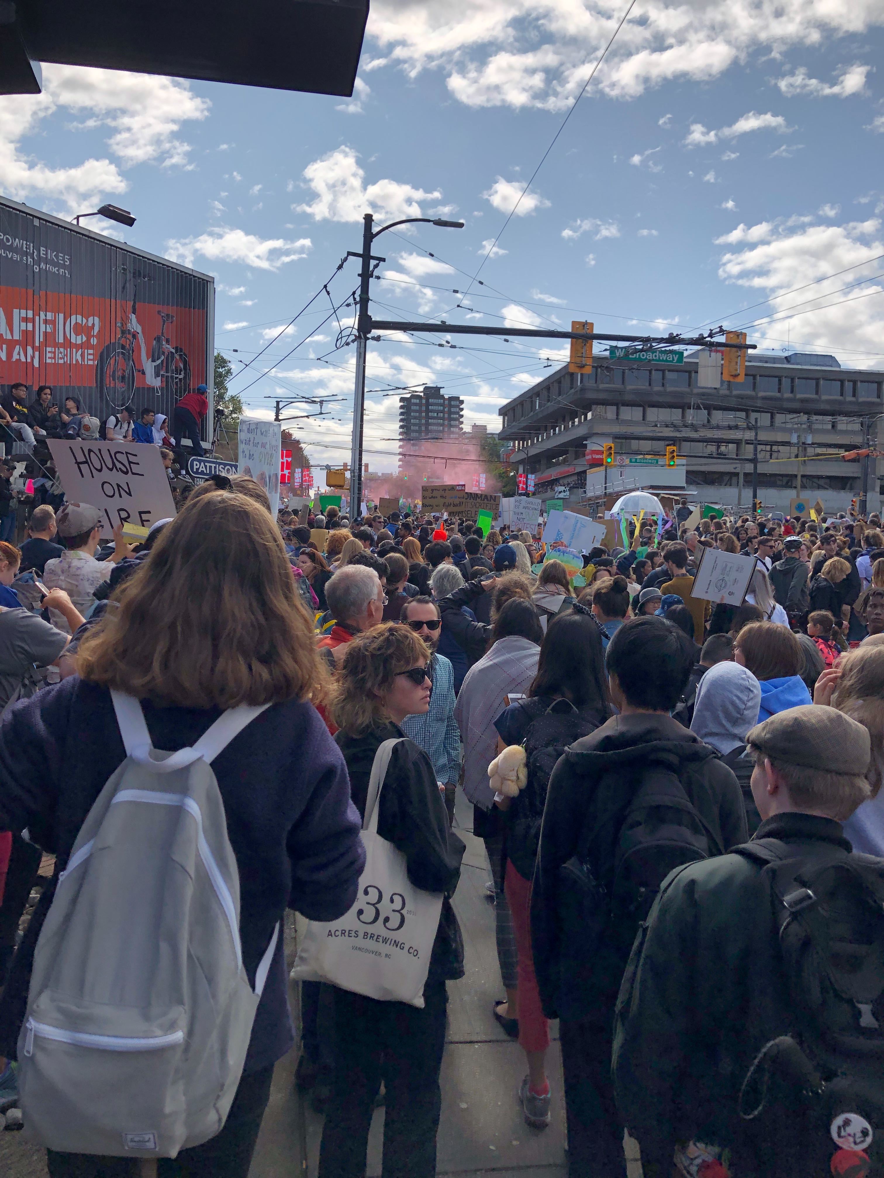 a large crowd fills a street in Vancouver, marching for the Climate Protest.