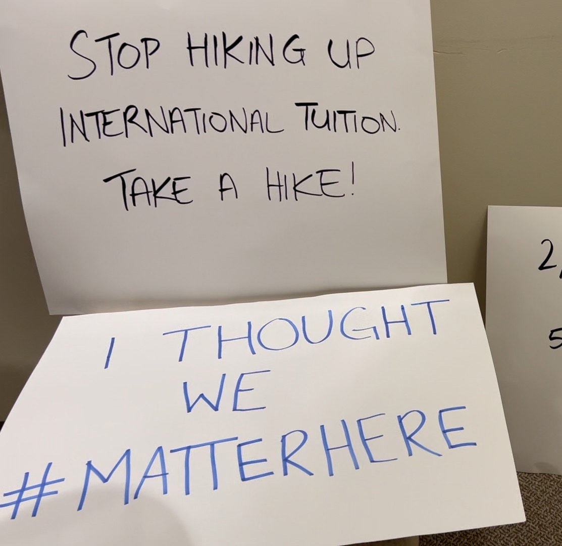 Signs in protest of international student tuition hike